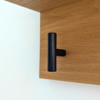 Solid Oak Coat Rack With Shelf - angled closeup view with black hooks