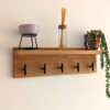 Solid Oak Coat Rack With Shelf - angled view with black hooks and ornaments