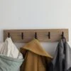 Oak coat rack with modern black hooks and 3 coats