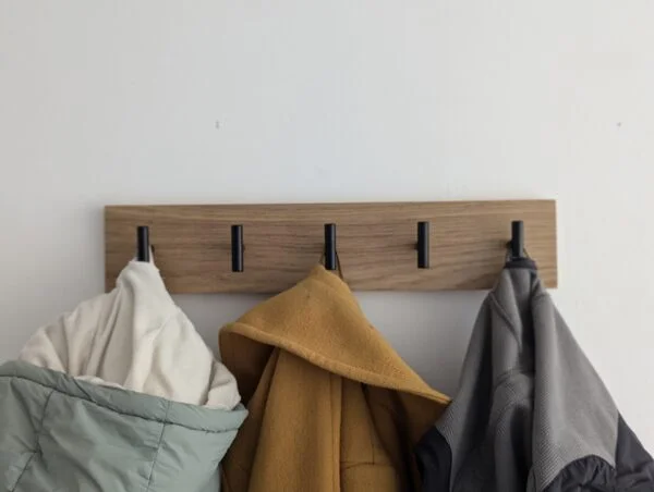 Oak coat rack with modern black hooks and 3 coats