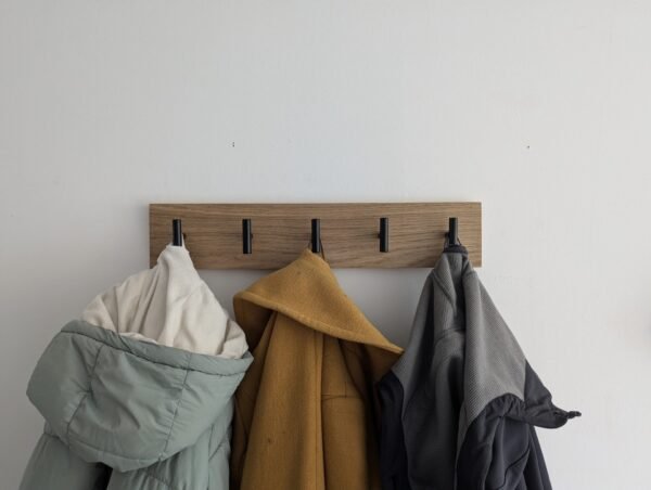 Oak coat rack with modern black hooks and 3 coats