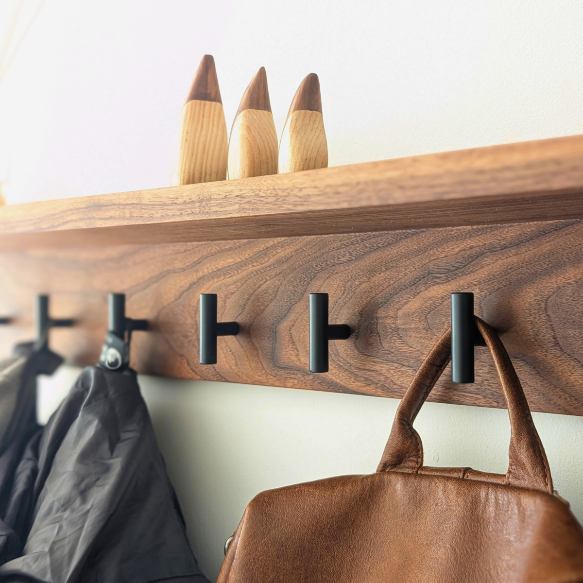 Modern Black Walnut Coat Rack With Shelf - angled view with coats