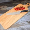 Solid Oak Chopping Board - Angled image on kitchen side with tomatoes and knife