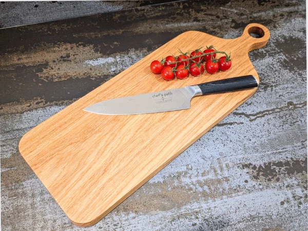 Solid Oak Chopping Board - Angled image on kitchen side with tomatoes and knife
