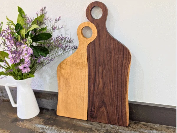 Romeo & Juliet serving boards stood up in kitchen next to flowers