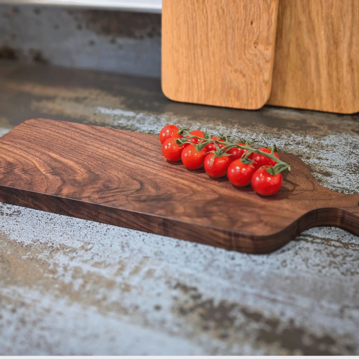 Solid Black Walnut Chopping Board - Angled image with tomatoes