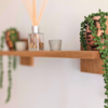 Modern Solid Oak Scandi Floating Shelf angled image with ornaments and plants