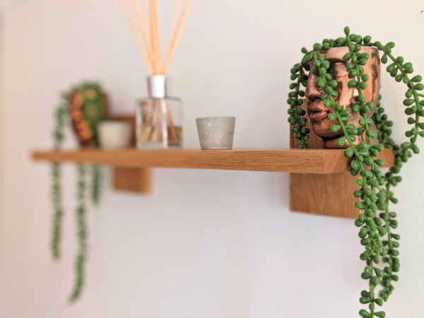 Modern Solid Oak Scandi Floating Shelf angled image with ornaments and plants