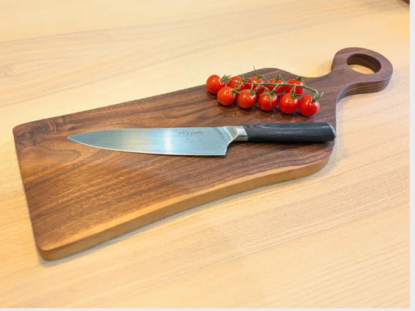 Black Walnut Romeo cutting board with knife, bowl and tomatoes