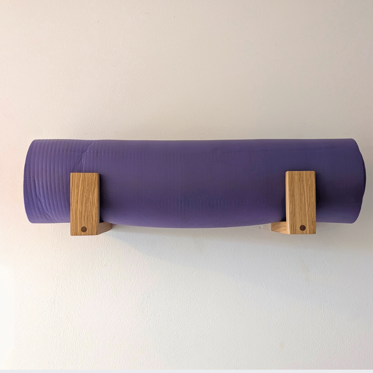Solid Oak yoga mat hooks - wall mounted close together with mat overhanging