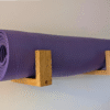 Solid Oak yoga mat hooks - wall mounted close together with mat overhanging, angled view