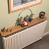 110cm no drill oak radiator shelf with ornaments - angled image