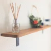 Angled view of wall mounted oak shelf