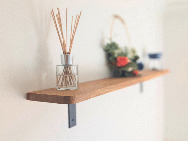 Angled view of wall mounted oak shelf