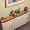 110cm no drill oak radiator shelf with ornaments - angled image