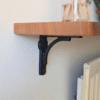 Oak radiator shelf with cast iron brackets