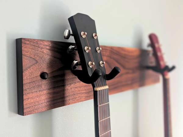 Solid Black Walnut Double Guitar Wall Mount - closeup angled image