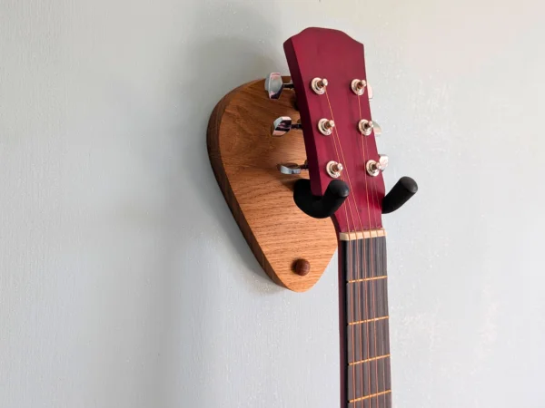 Solid Oak Plectrum Guitar Mount - closeup angled image with guitar