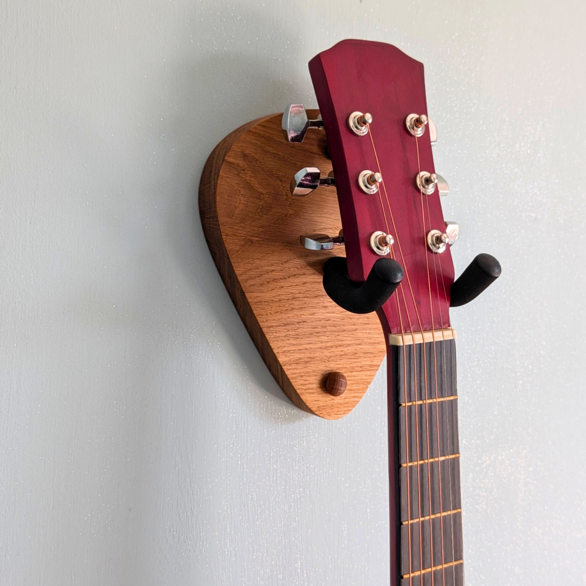 Solid Oak Plectrum Guitar Mount - closeup angled image with guitar