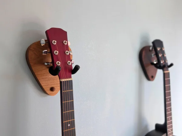Solid Oak Plectrum Guitar Mount - angled image with guitars