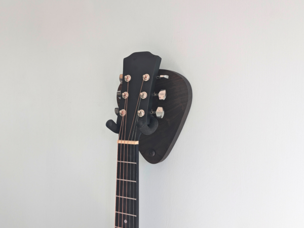 Solid Black Walnut Plectrum Guitar Mount - with guitar, angled image, closeup
