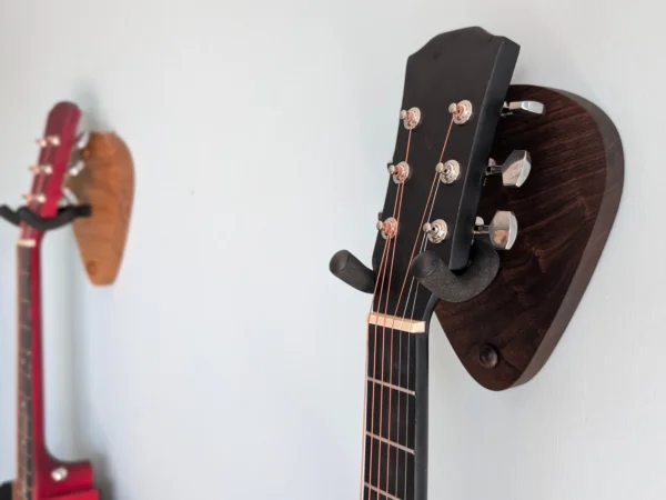 Solid Oak Plectrum Guitar Mount - with walnut version and guitars, angled