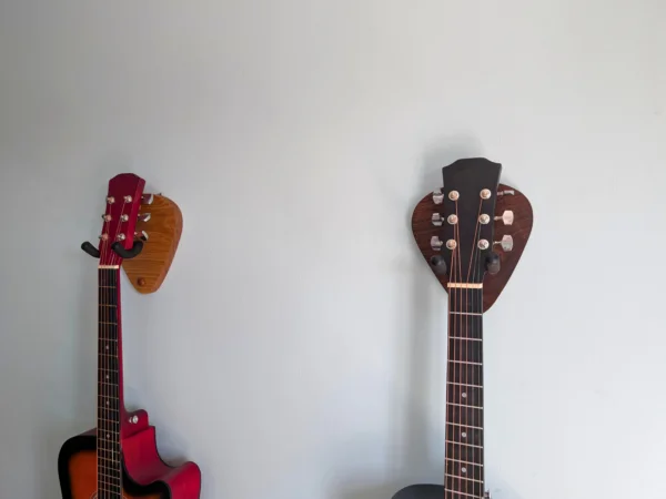 Solid Oak Plectrum Guitar Mount - with walnut version and guitars, angled