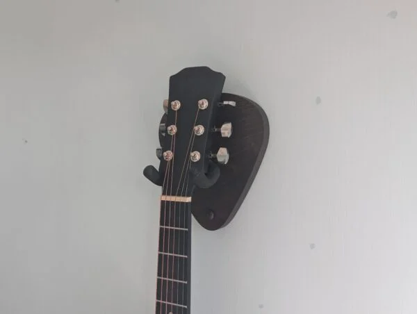 Solid Black Walnut Plectrum Guitar Mount - with guitar, angled image, closeup