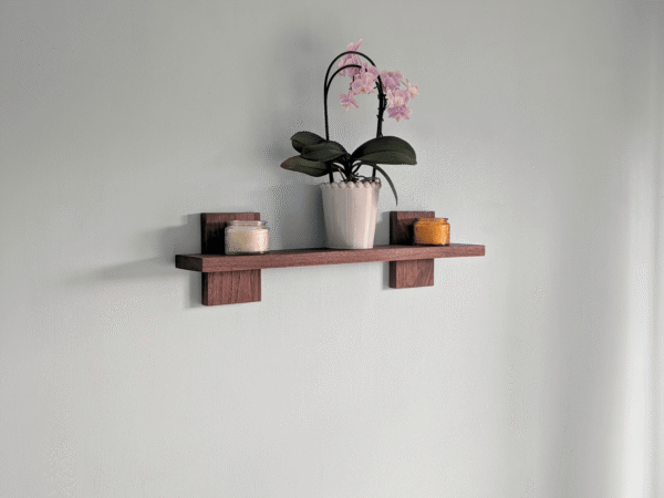 Modern Solid Black Walnut Scandi Floating Shelf - angled image with candles and orchid