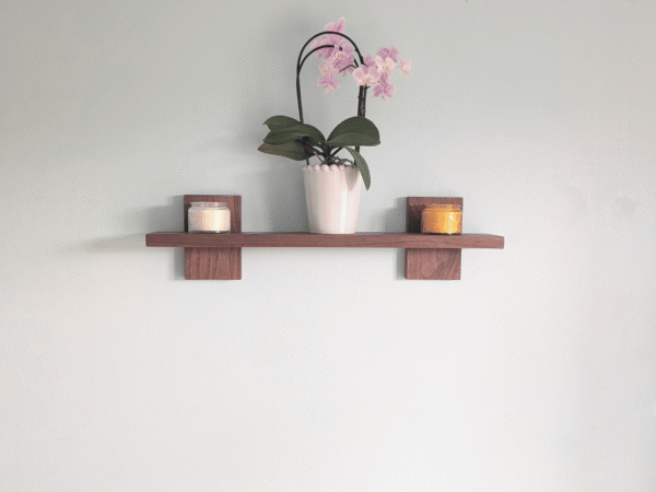 Modern Solid Black Walnut Scandi Floating Shelf - straight image with candles and orchid