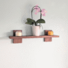 Modern Solid Black Walnut Scandi Floating Shelf - angled image with candles and orchid