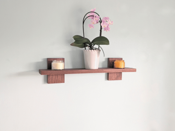 Modern Solid Black Walnut Scandi Floating Shelf - angled image with candles and orchid