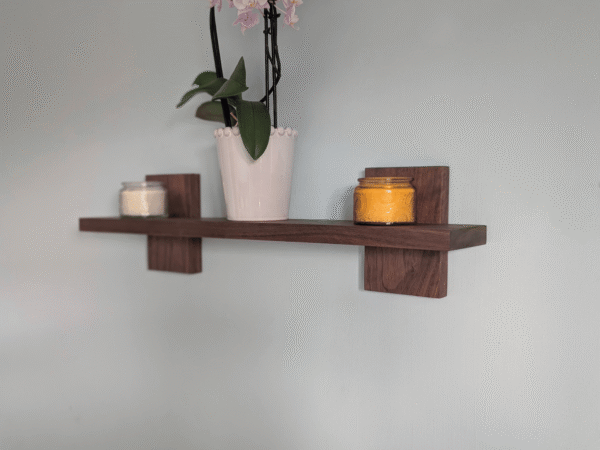 Modern Solid Black Walnut Scandi Floating Shelf - angled image with candles and orchid