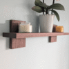 Modern Solid Black Walnut Scandi Floating Shelf - angled image with candles and orchid