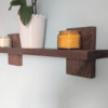 Modern Solid Black Walnut Scandi Floating Shelf - Closeup image with candles and orchid