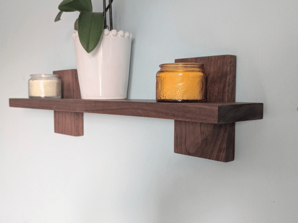 Modern Solid Black Walnut Scandi Floating Shelf - Closeup image with candles and orchid