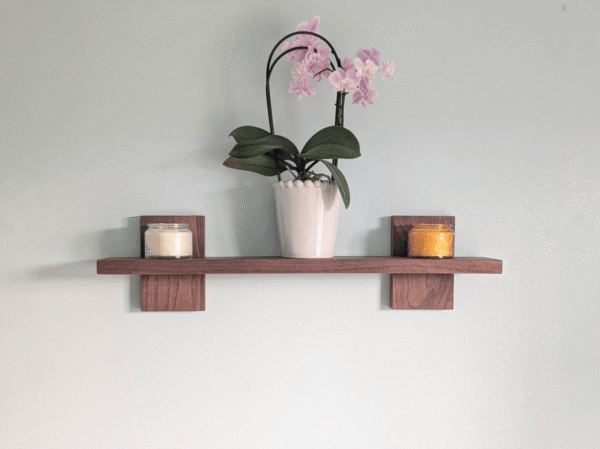 Modern Solid Black Walnut Scandi Floating Shelf - Straight image with candles and orchid